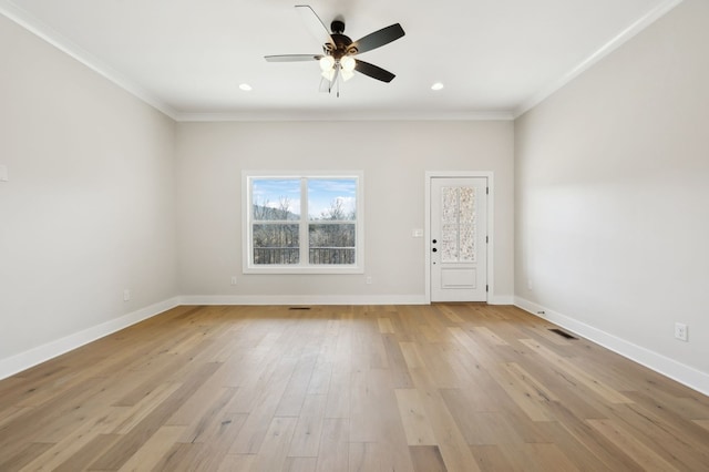 unfurnished room with light wood-type flooring, baseboards, ceiling fan, and crown molding