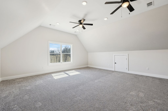 additional living space featuring visible vents, baseboards, lofted ceiling, and a ceiling fan