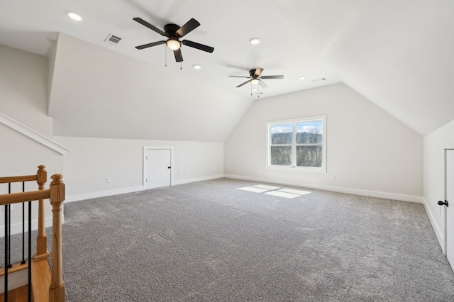 additional living space featuring a ceiling fan, visible vents, carpet floors, baseboards, and vaulted ceiling