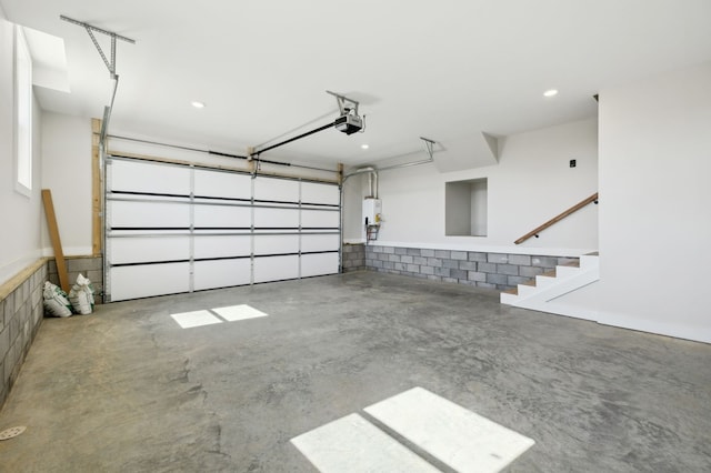 garage with water heater and a garage door opener