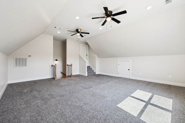 additional living space featuring visible vents, lofted ceiling, and ceiling fan