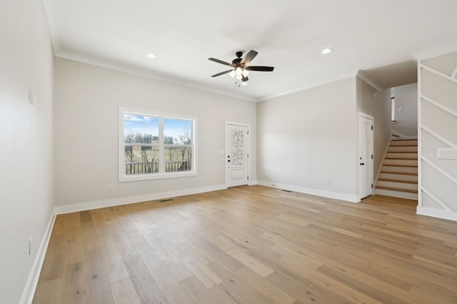 unfurnished living room with crown molding, baseboards, stairway, light wood-style floors, and a ceiling fan