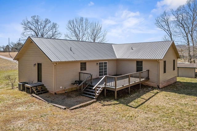 rear view of property featuring a lawn, central AC unit, crawl space, metal roof, and a deck