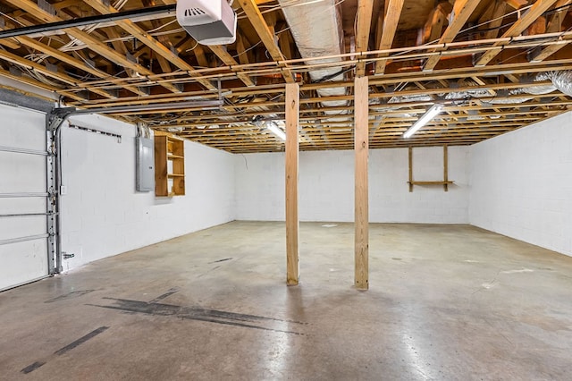 basement with a garage and electric panel