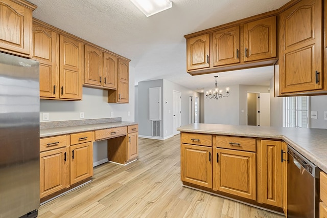 kitchen featuring brown cabinets, light countertops, visible vents, appliances with stainless steel finishes, and light wood-type flooring