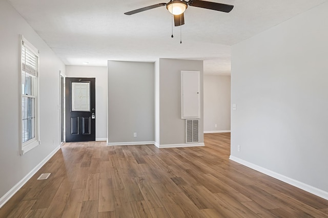 interior space with baseboards, visible vents, and wood finished floors