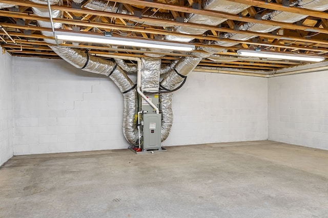 unfinished basement featuring heating unit