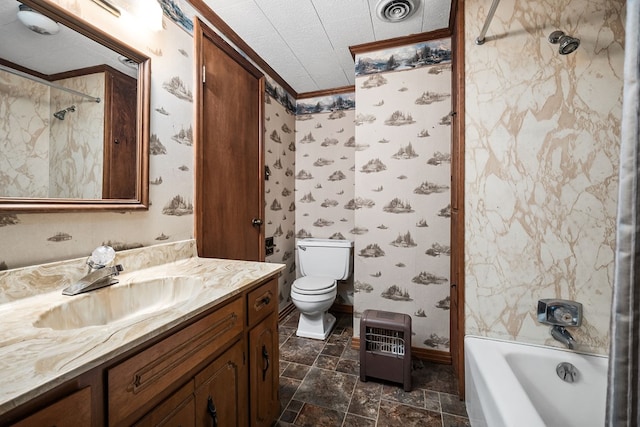 bathroom featuring visible vents, toilet, stone finish flooring, vanity, and wallpapered walls