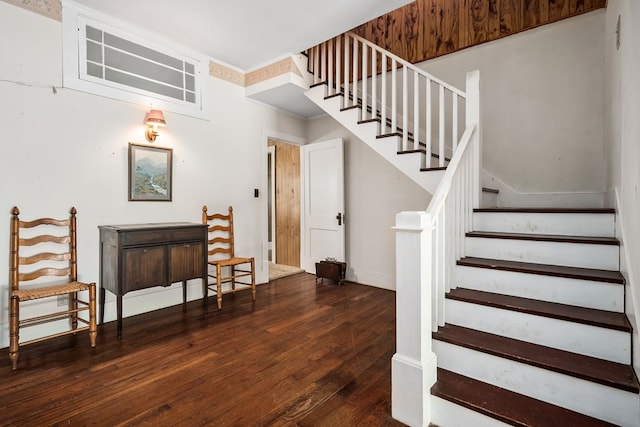 staircase with baseboards and wood finished floors