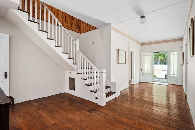 entrance foyer with baseboards, stairway, dark wood finished floors, and ornamental molding