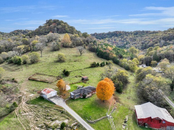 birds eye view of property with a view of trees