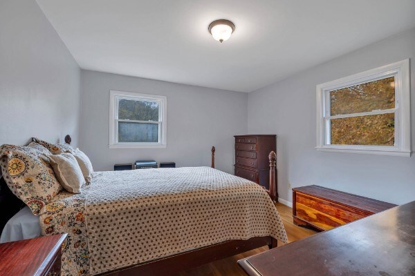 bedroom with wood finished floors and baseboards