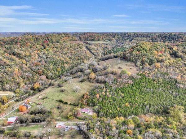 drone / aerial view featuring a forest view