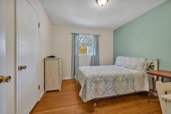 bedroom featuring light wood-style flooring and baseboards