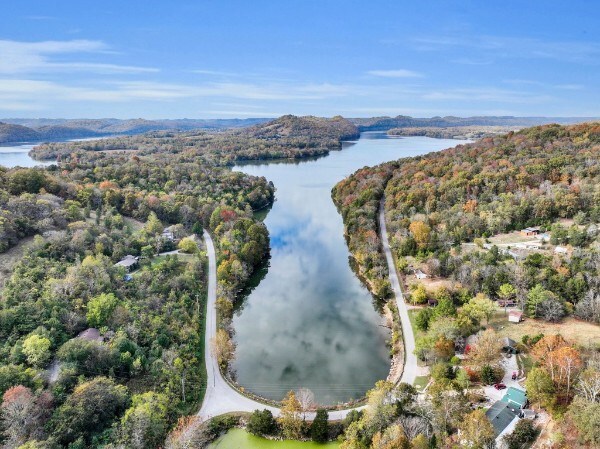 aerial view featuring a water view and a view of trees