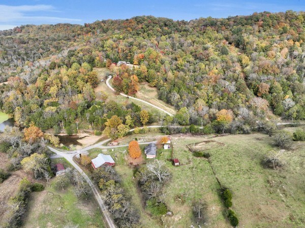 drone / aerial view featuring a forest view