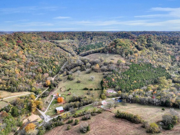 drone / aerial view featuring a wooded view