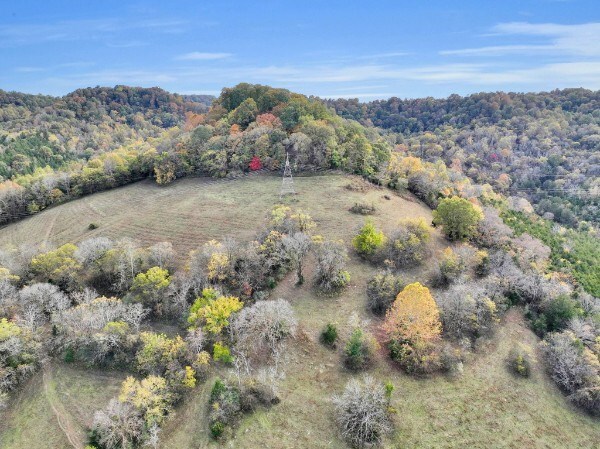 drone / aerial view featuring a wooded view