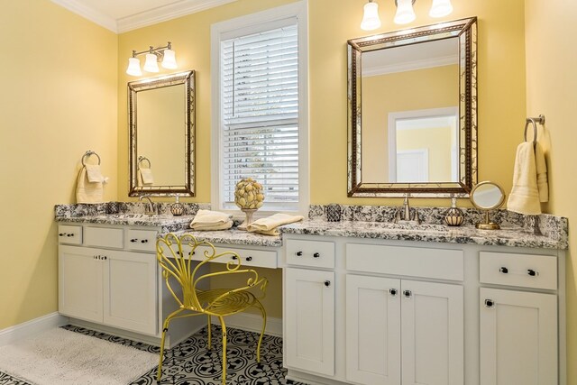 full bathroom with ornamental molding, two vanities, and a sink