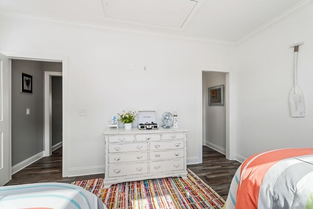 bedroom with ornamental molding, dark wood-style flooring, and baseboards