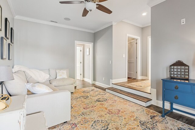 living area featuring crown molding, visible vents, and dark wood-type flooring