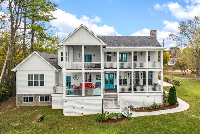 view of front of home with a balcony, covered porch, a chimney, and board and batten siding