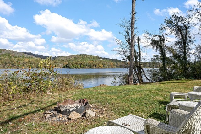 view of yard with a water view and a wooded view