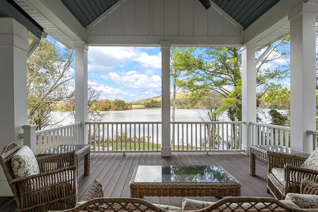 wooden terrace featuring a water view