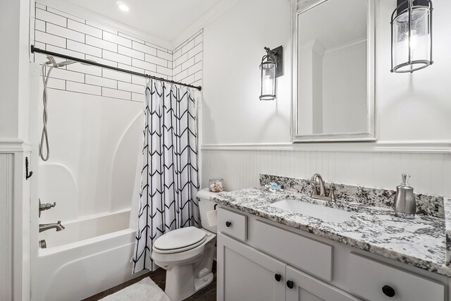 bathroom featuring a wainscoted wall, shower / tub combo, toilet, and vanity