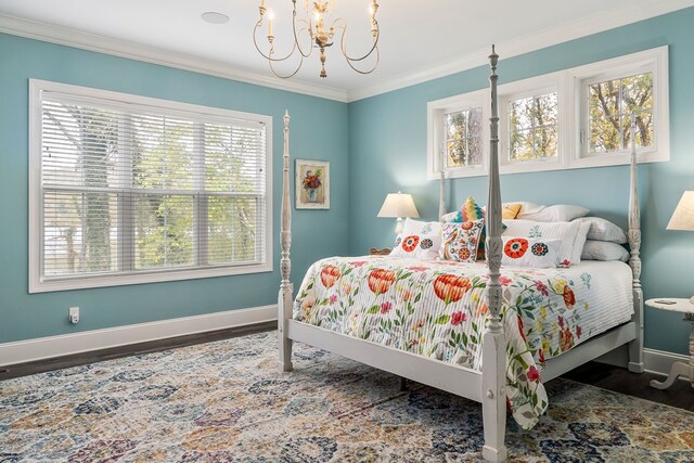 bedroom with baseboards, a notable chandelier, wood finished floors, and crown molding