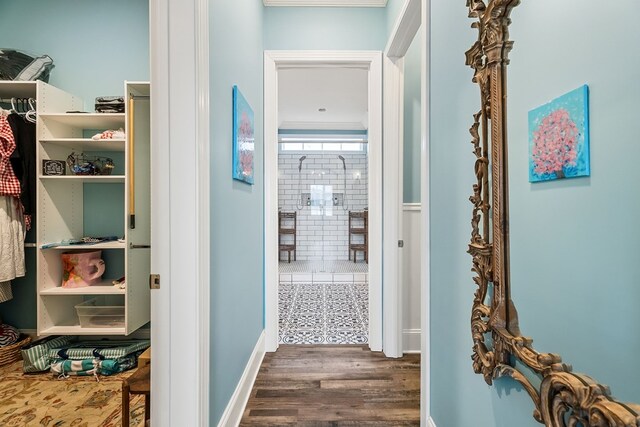 hallway featuring dark wood-style floors and baseboards