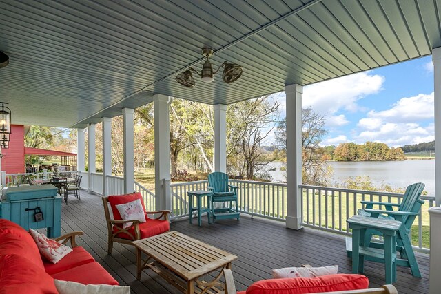 wooden deck featuring outdoor dining space and a water view