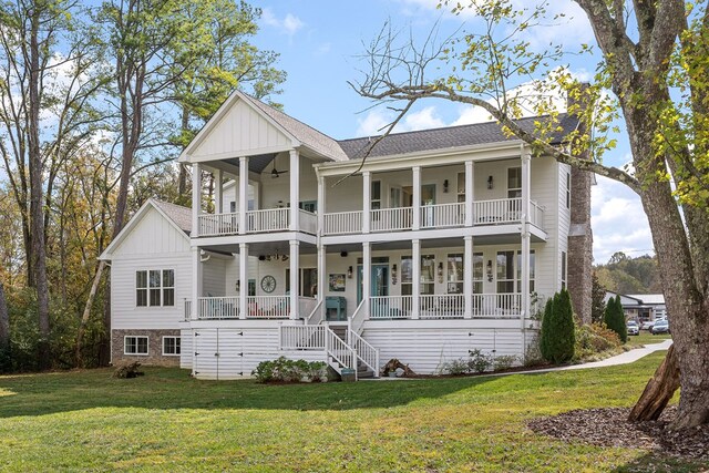 view of front of property featuring a ceiling fan, a balcony, covered porch, board and batten siding, and a front yard