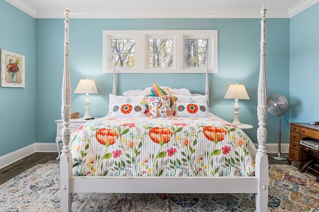 bedroom with ornamental molding, dark wood-type flooring, and baseboards