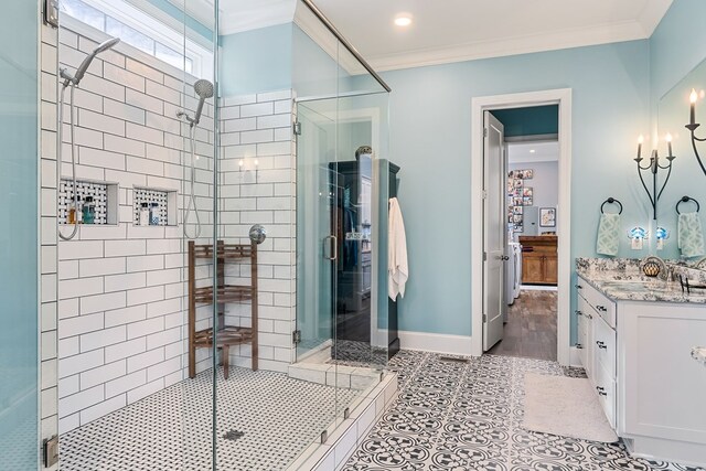 full bath featuring a shower stall, baseboards, crown molding, and tile patterned floors