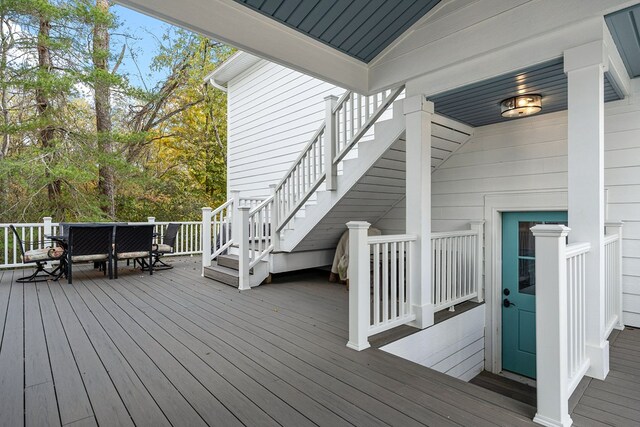 wooden terrace with stairway and outdoor dining area