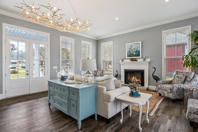 sitting room featuring dark wood finished floors, french doors, and crown molding