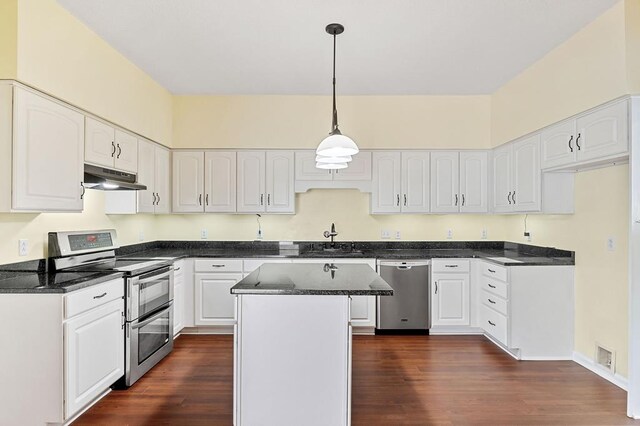 kitchen featuring a kitchen island, appliances with stainless steel finishes, hanging light fixtures, under cabinet range hood, and white cabinetry