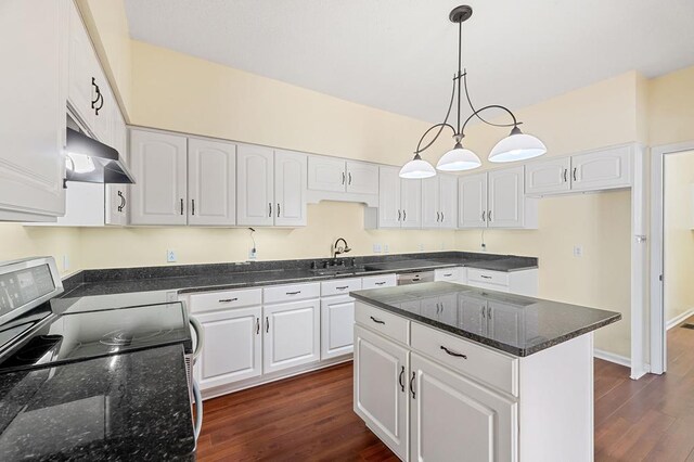 kitchen with white cabinets, wall chimney exhaust hood, hanging light fixtures, stainless steel range with electric cooktop, and a sink