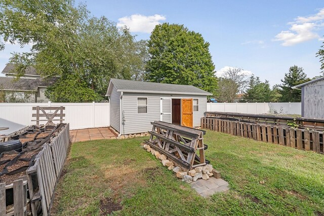 view of yard with a fenced backyard and an outdoor structure