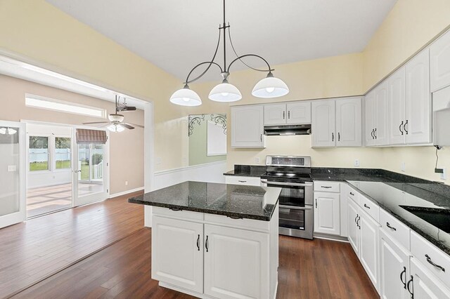 kitchen featuring under cabinet range hood, white cabinetry, and double oven range