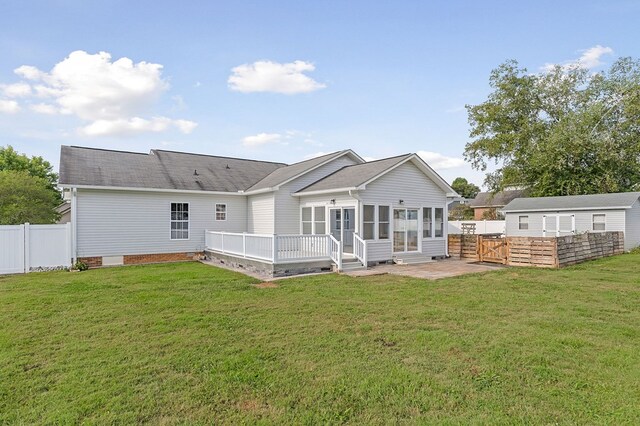 back of house with crawl space, fence, a patio, and a yard