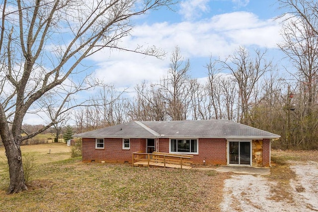 view of front of property with a deck and brick siding