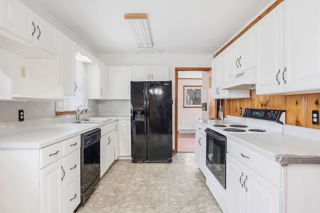 kitchen featuring under cabinet range hood, light countertops, black appliances, white cabinetry, and a sink