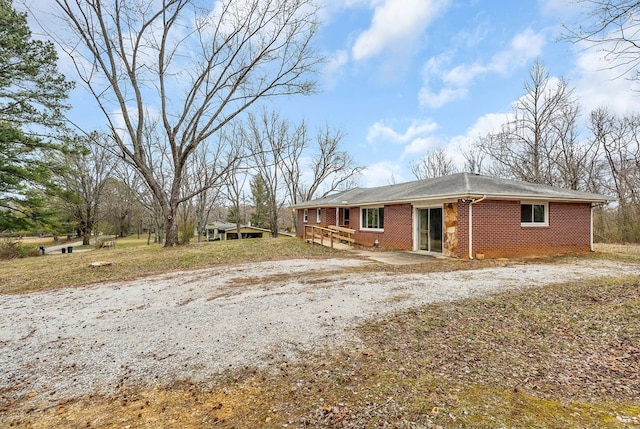 view of front facade with brick siding and driveway