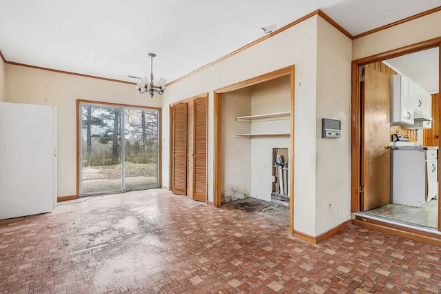 unfurnished dining area with brick floor, baseboards, a chandelier, and ornamental molding