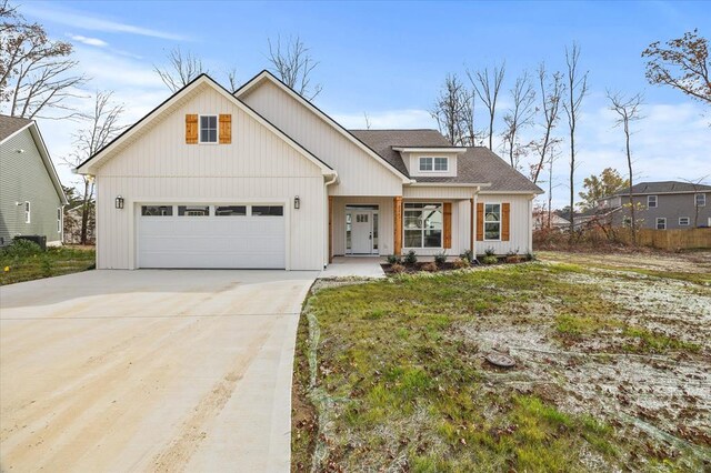 modern farmhouse with concrete driveway, roof with shingles, and an attached garage