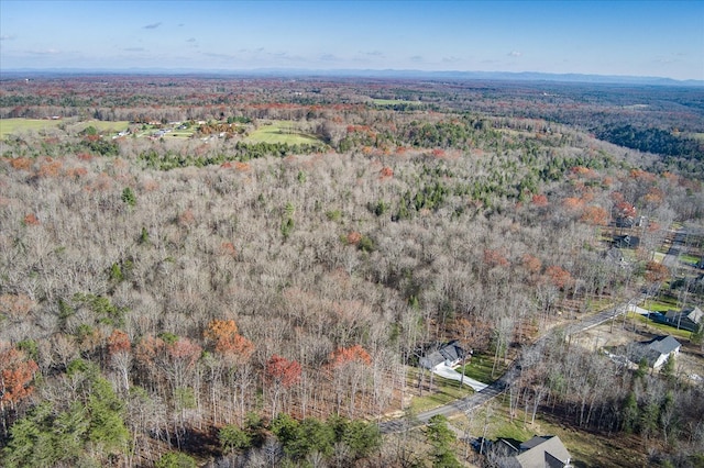 birds eye view of property featuring a wooded view