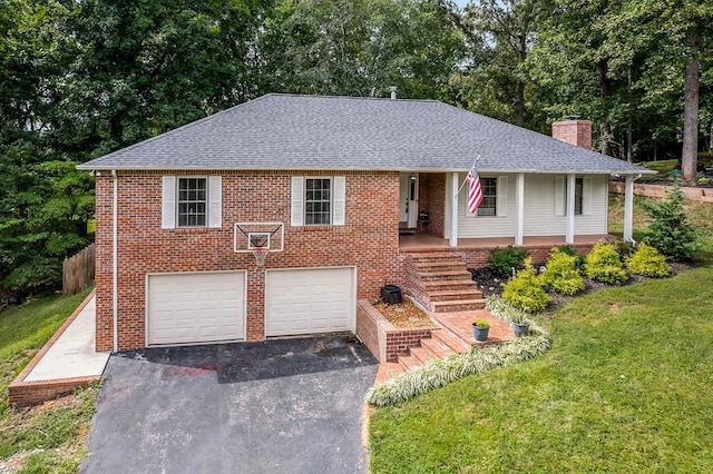 view of front facade with aphalt driveway, covered porch, a garage, brick siding, and a chimney