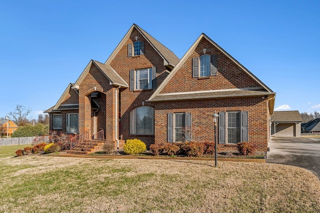 traditional-style house with brick siding and a front yard